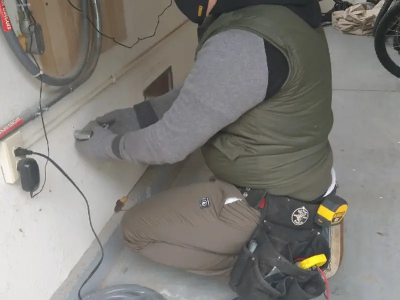 Electrician performing outlet wiring in a Decatur garage